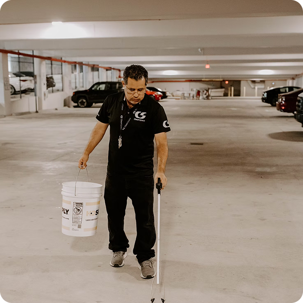Man cleaning a parking garage.