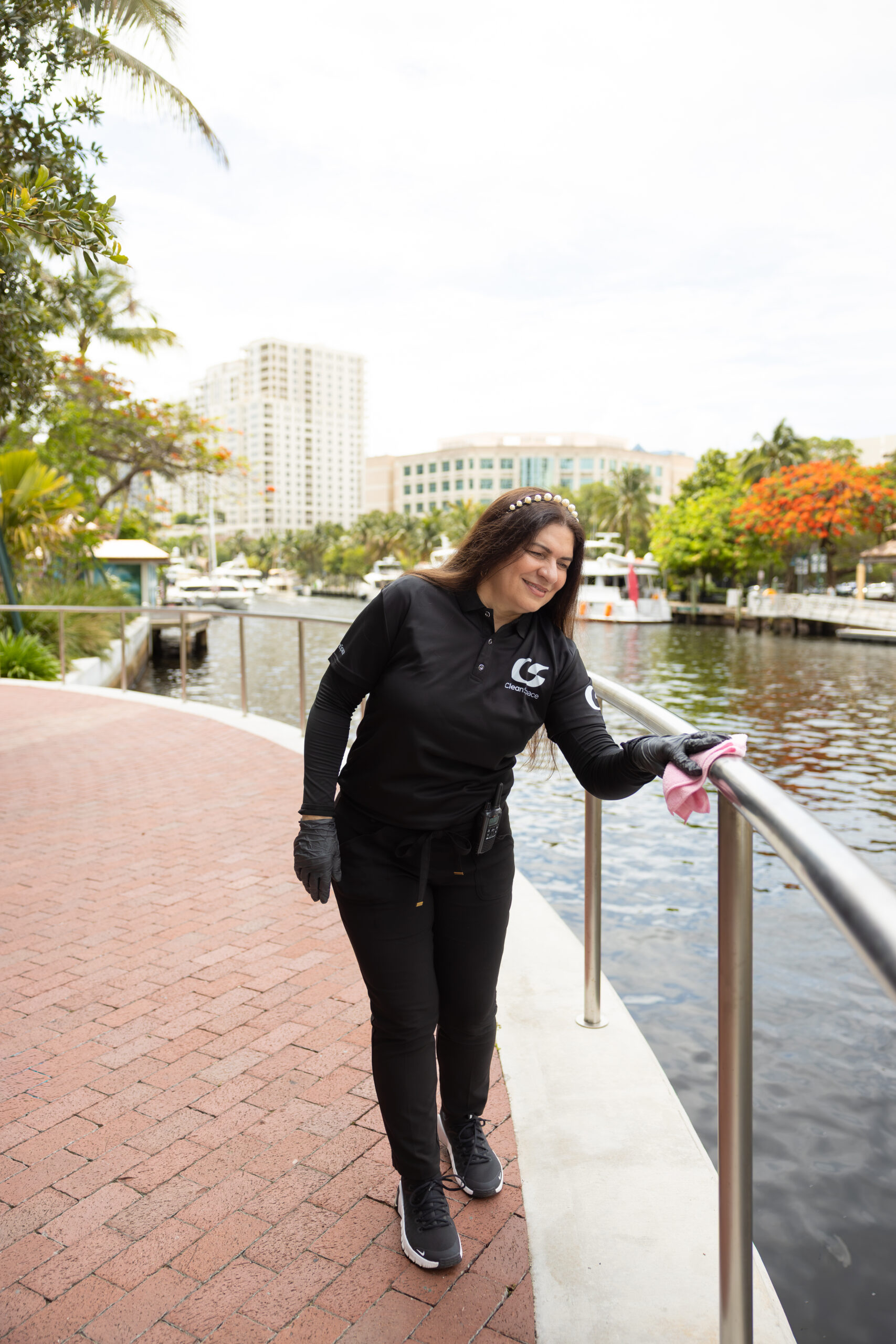 Clean Space cleaner wiping a riverwalk railing in Fort Lauderdale, Florida
